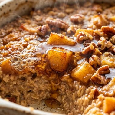 Ultra close up macro of golden baked apple pie oatmeal with caramelized honeycrisp apples and pecans