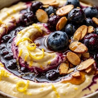 Ultra creamy whipped lemon blueberry cottage cheese breakfast bowl topped with fresh berries and chia seeds